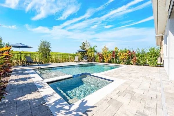 a view of swimming pool with outdoor seating and plants