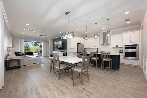 a large kitchen with a table and chairs