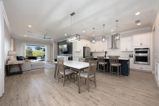 a kitchen with a sink a stove a refrigerator and cabinets