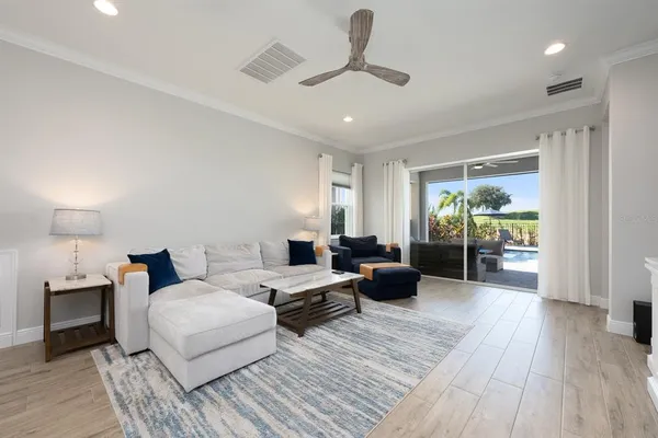 a bedroom with furniture and a large window