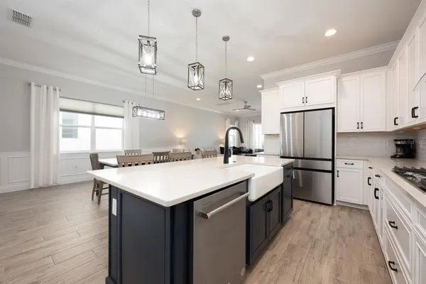 a kitchen with a sink a stove a refrigerator and cabinets