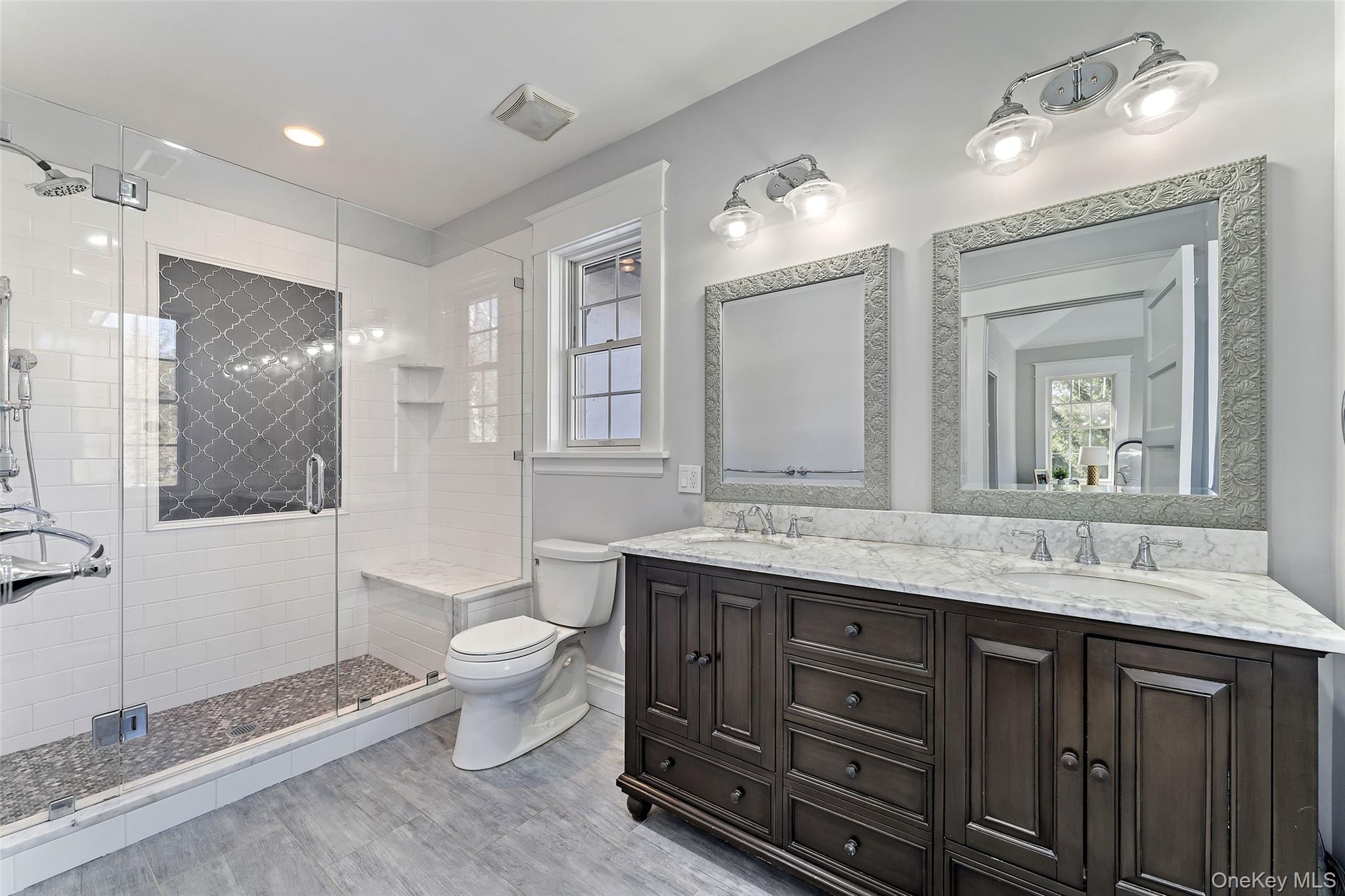 12 Swarthmore Road Scarsdale, NY 10583 - Photo 18 of 34 Elegant Primary Bath Featuring Double Vanity and Spacious Walk-In Glass Enclosed Shower