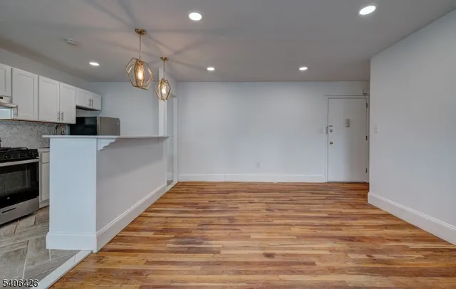 a view of kitchen with microwave and cabinets