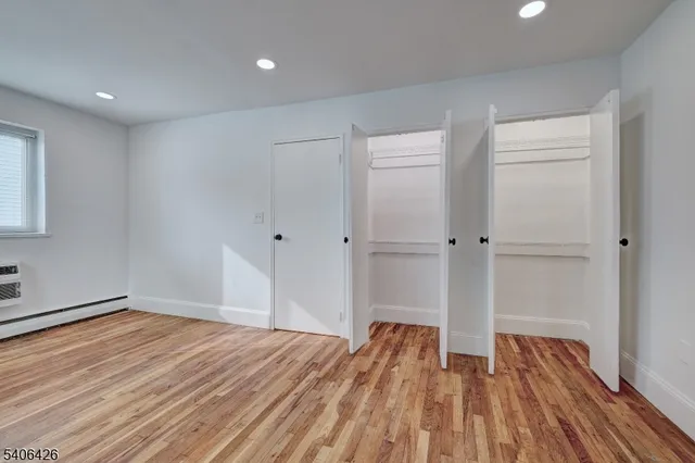 a view of a room with wooden floor and white walls