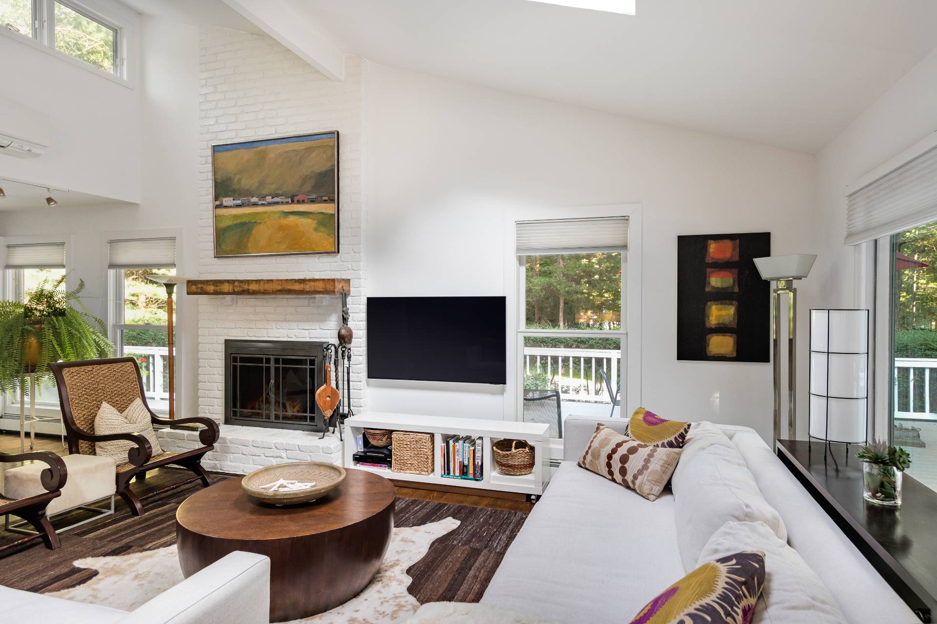 102 Rutland Road East Hampton, NY 11937 - Photo 3 of 20 a living room with furniture a fireplace and a flat screen tv