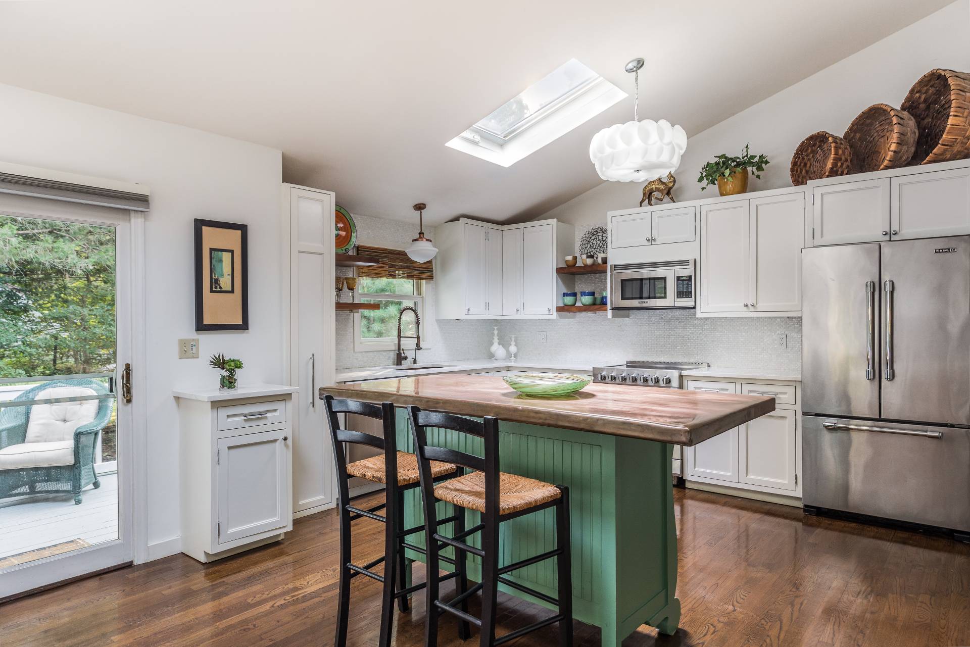 102 Rutland Road East Hampton, NY 11937 - Photo 7 of 20 a kitchen with stainless steel appliances a table chairs and a refrigerator
