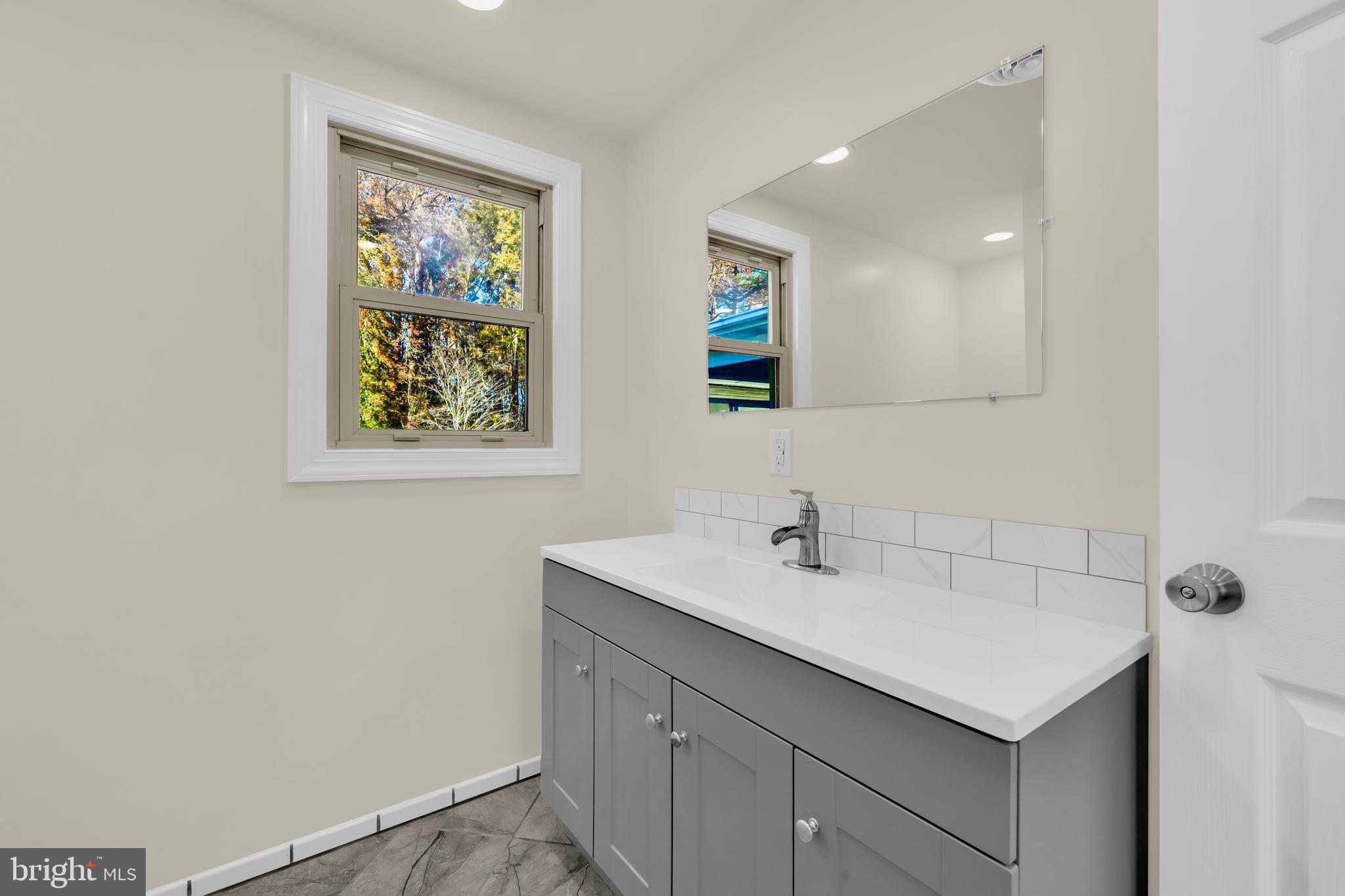 334 Deep Shore Road Denton, MD 21629 - Photo 18 of 48 a bathroom with a sink mirror and vanity