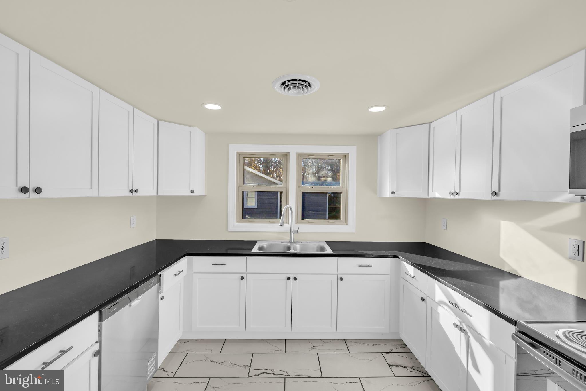 334 Deep Shore Road Denton, MD 21629 - Photo 29 of 48 a kitchen with granite countertop white cabinets and white appliances