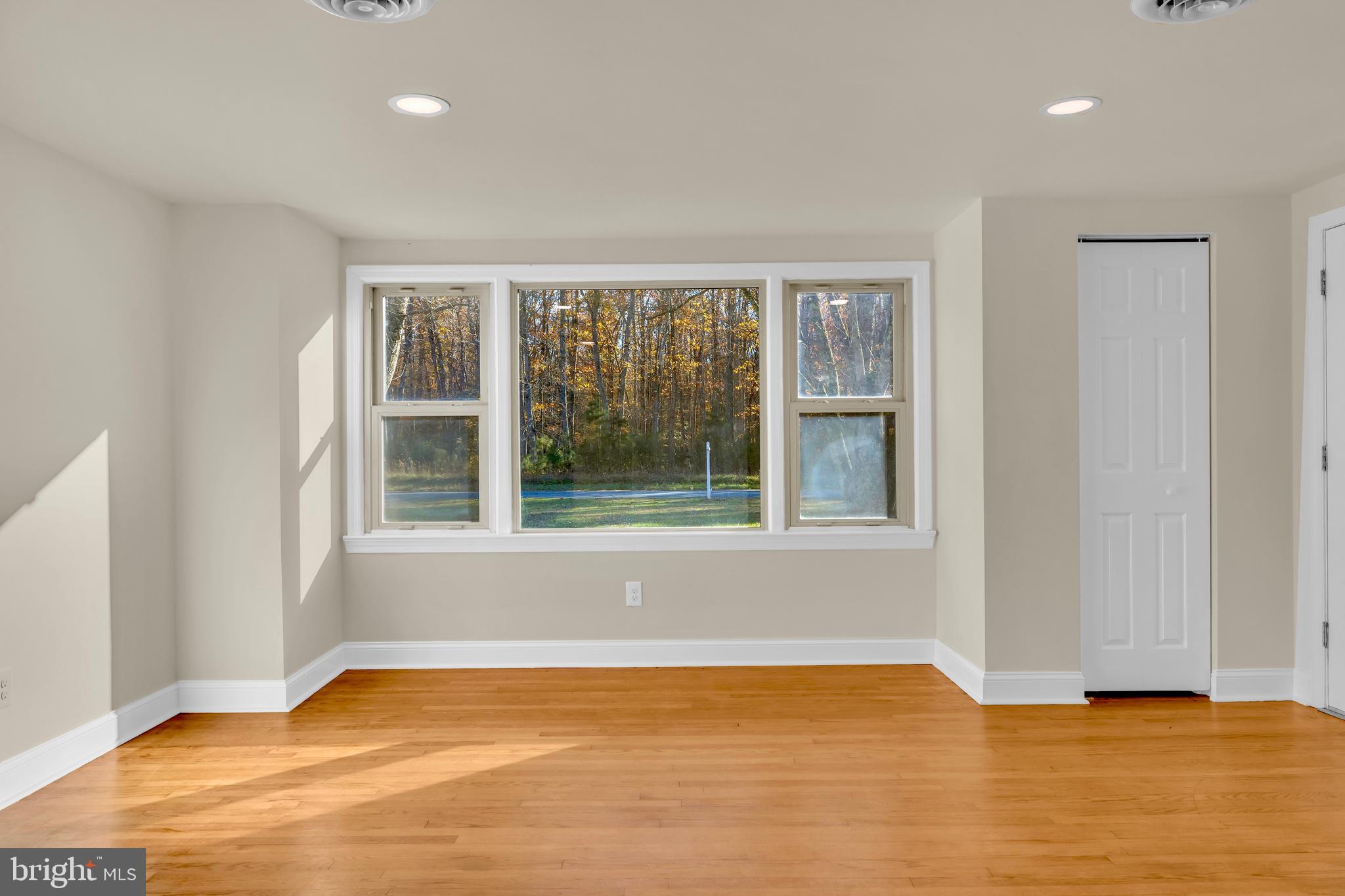 334 Deep Shore Road Denton, MD 21629 - Photo 35 of 48 a view of an empty room with wooden floor and a window