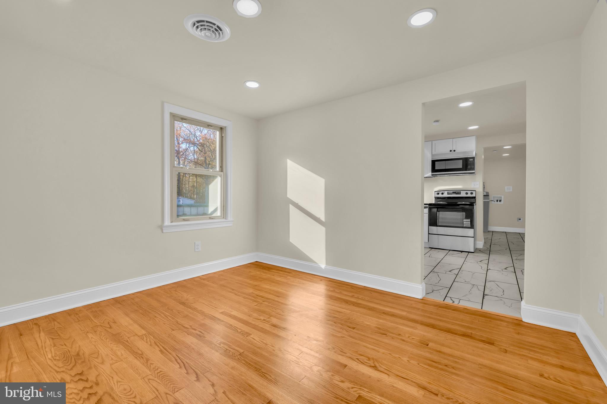 334 Deep Shore Road Denton, MD 21629 - Photo 36 of 48 a view of empty room with wooden floor and windows