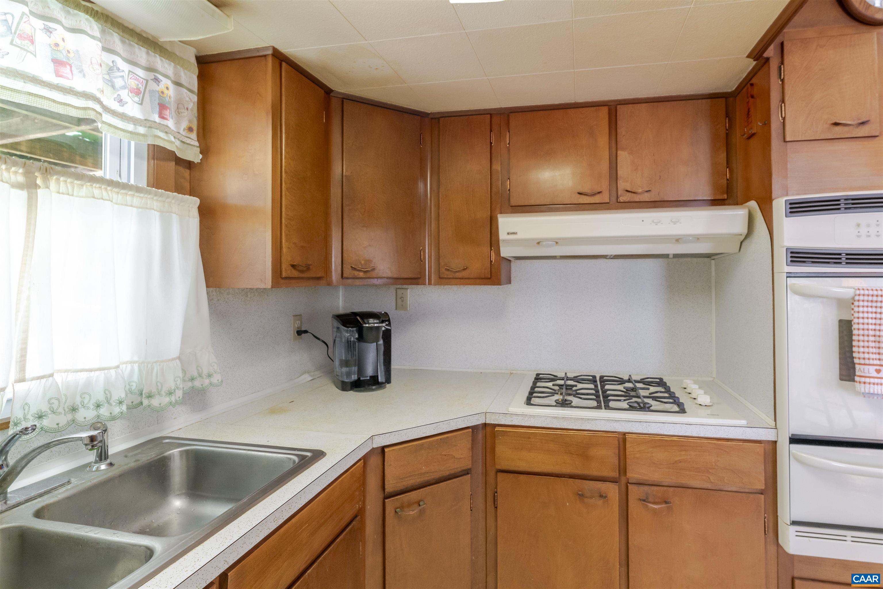 906 Alta Street Staunton, VA 24401 - Photo 11 of 34 a kitchen with stainless steel appliances granite countertop a sink stove and cabinets
