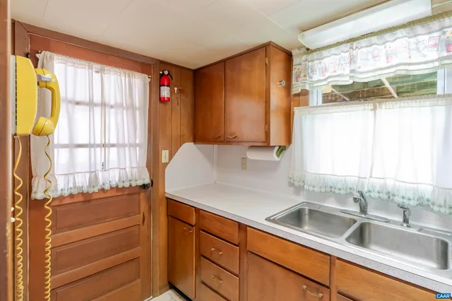 a kitchen with stainless steel appliances cabinets and a large window