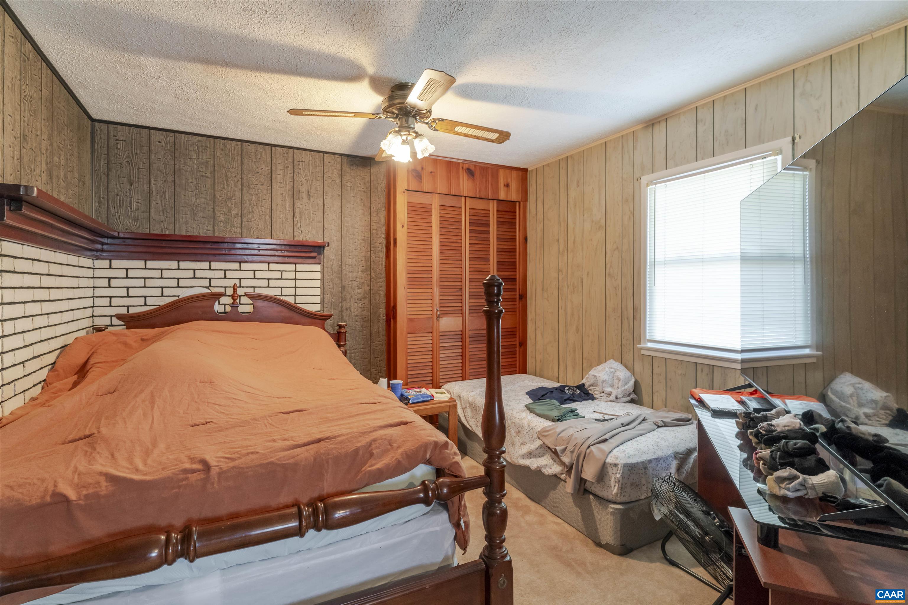 906 Alta Street Staunton, VA 24401 - Photo 14 of 34 a bedroom with a bed and a chandelier