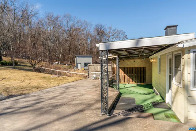 a view of a swimming pool with a bench in patio
