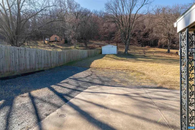 a view of backyard with wooden fence