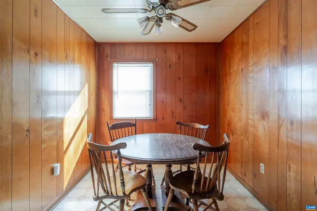 a view of a dining room with furniture and window