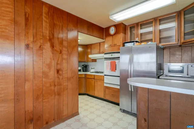 a kitchen with stainless steel appliances granite countertop a sink and cabinets