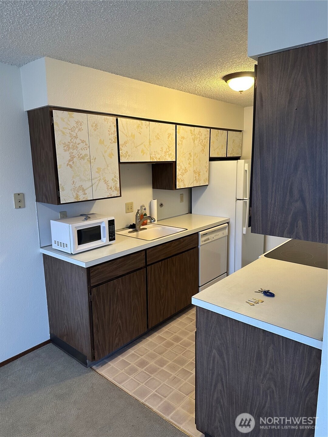 3828 Whitman Avenue North Seattle, WA 98103 - Photo 4 of 8 a kitchen with stainless steel appliances a sink stove and refrigerator