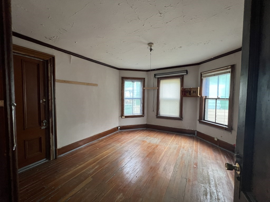 2 Stevens Road Worcester, MA 01603 - Photo 9 of 22 a view of an empty room with wooden floor and a window