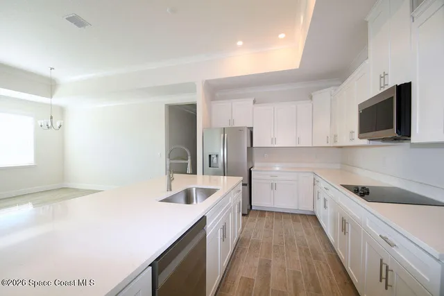 a kitchen with a sink dishwasher stove and refrigerator