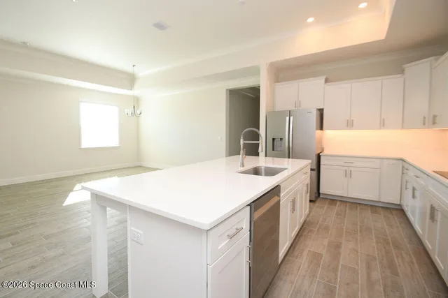 a kitchen with a sink a window and cabinets