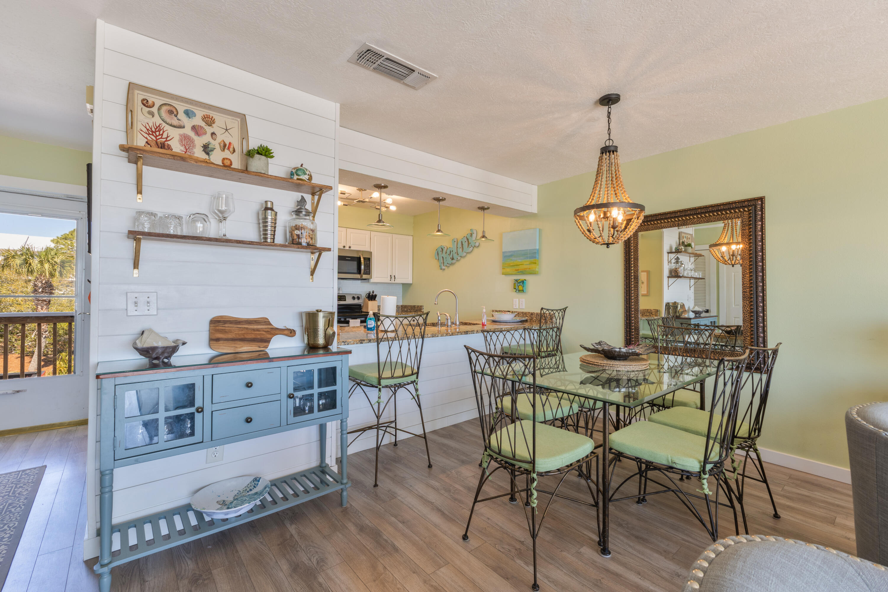 207 Beachfront Trail, Unit 10 Santa Rosa Beach, FL 32459 - Photo 2 of 47 a view of a dining room and livingroom with furniture wooden floor a rug and a chandelier