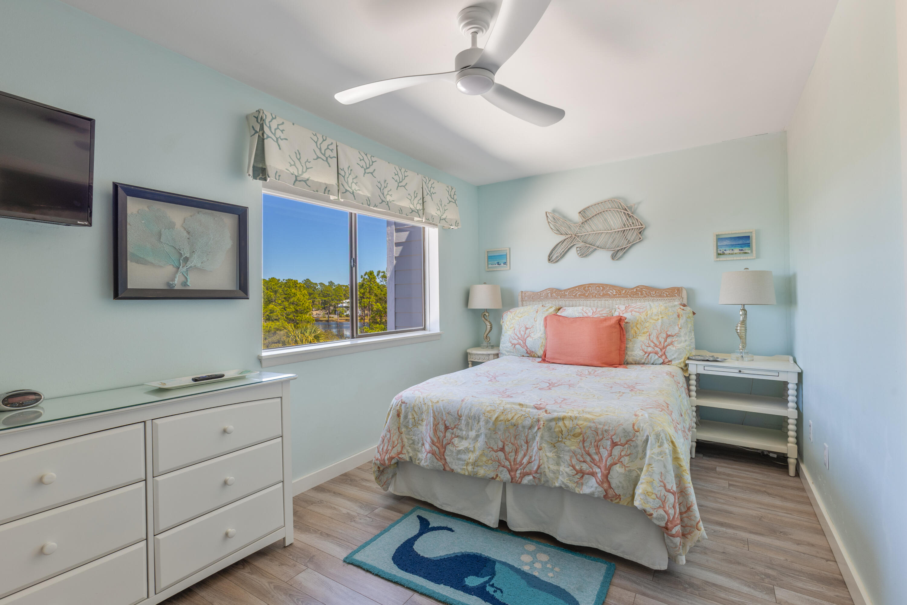207 Beachfront Trail, Unit 10 Santa Rosa Beach, FL 32459 - Photo 23 of 47 a bedroom with a bed and a chandelier