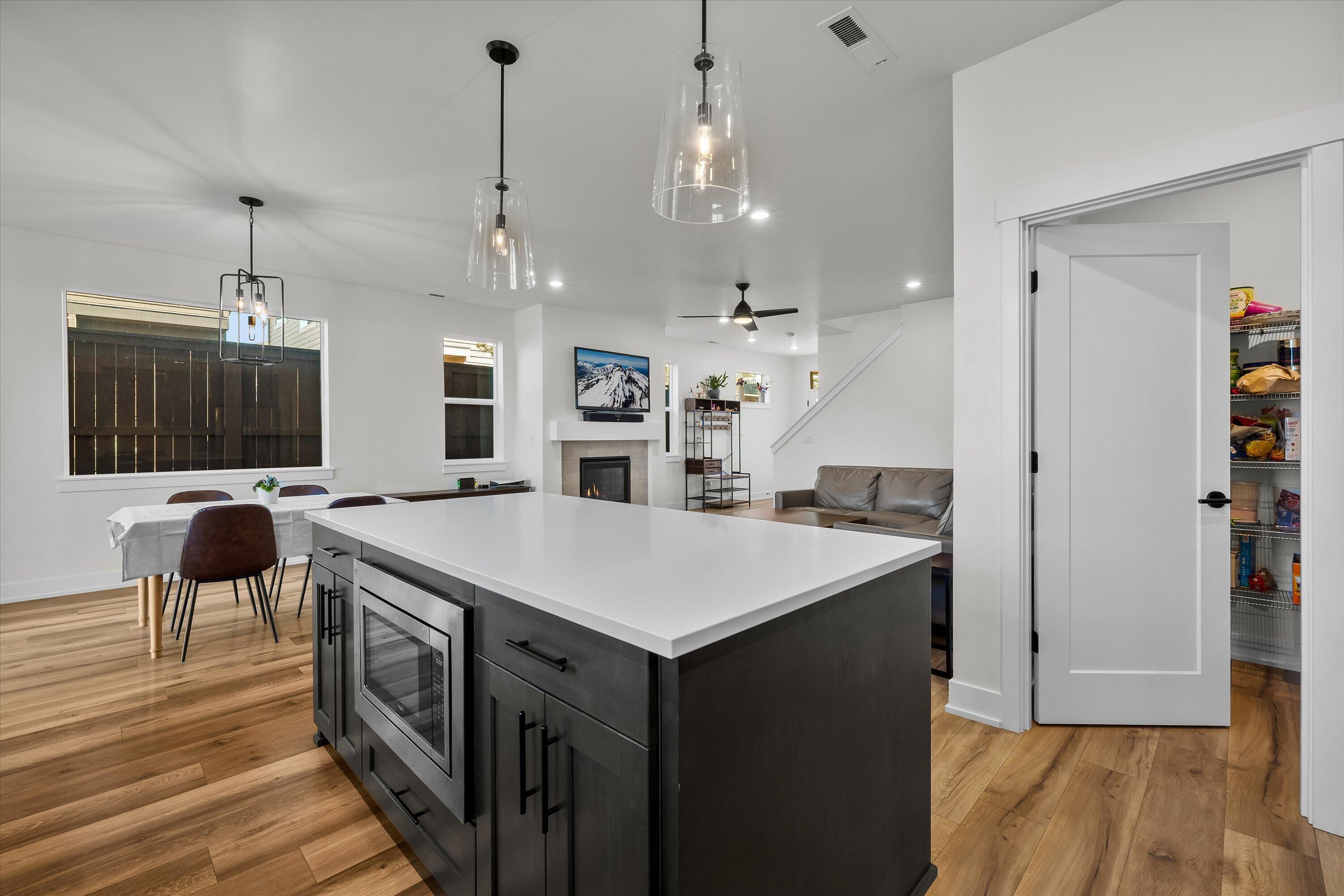 60903 Southeast Epic Place Bend, OR 97702 - Photo 14 of 48 a large kitchen with a counter space a sink stainless steel appliances and cabinets