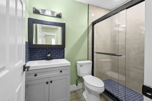 a bathroom with a toilet sink and a mirror
