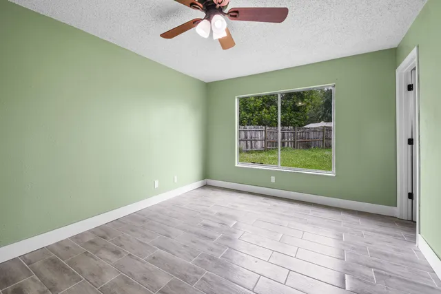 a view of room with window and ceiling fan