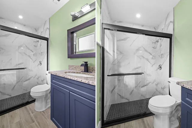 a bathroom with a granite countertop sink toilet and shower