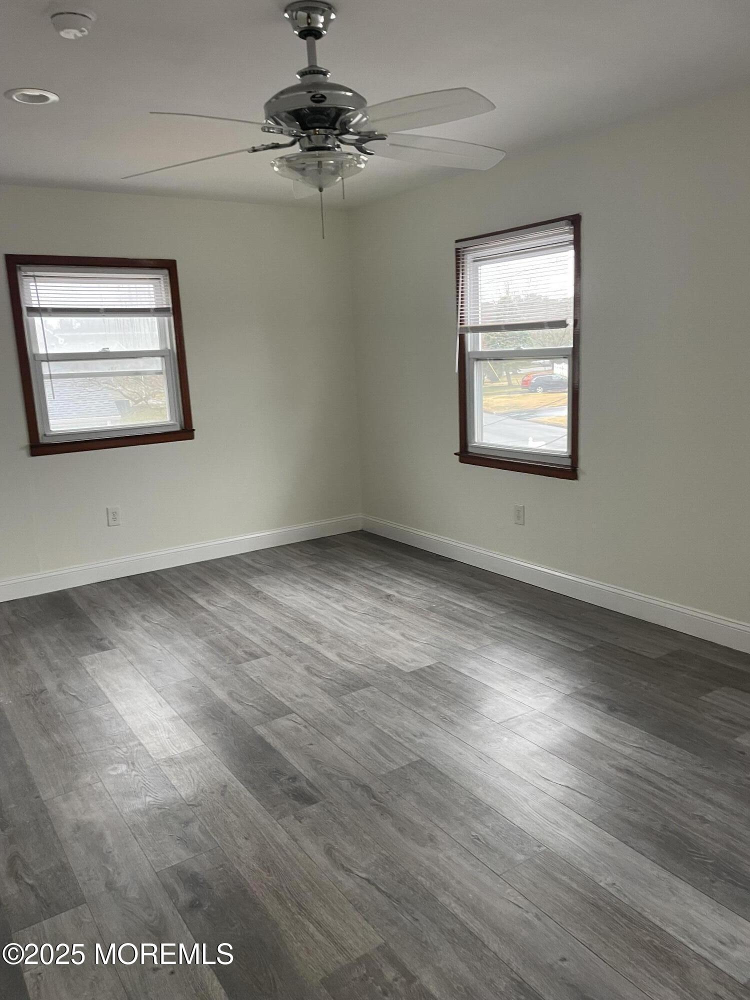 69 Mallard Road Bayville, NJ 08721 - Photo 14 of 21 a view of an empty room with wooden floor and a window