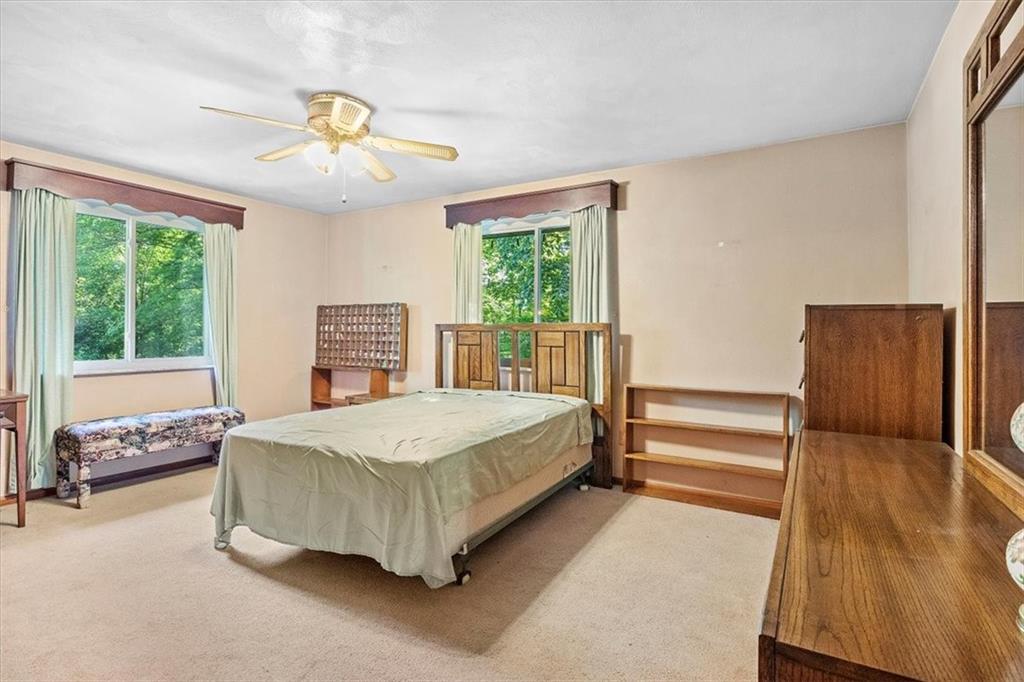 664 Duff Road Sewickley, PA 15143 - Photo 22 of 24 a spacious bedroom with a bed and wooden floor