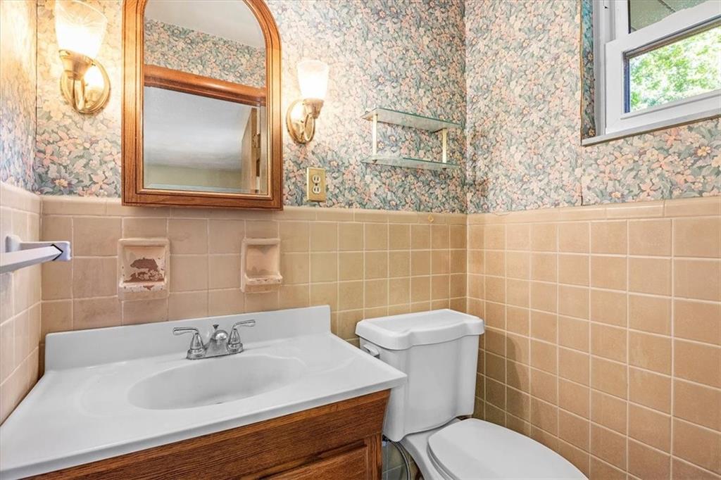 664 Duff Road Sewickley, PA 15143 - Photo 24 of 24 a bathroom with a sink mirror toilet and next to a window