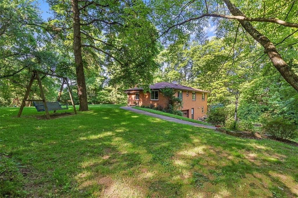 664 Duff Road Sewickley, PA 15143 - Photo 6 of 24 a backyard of a house with table and chairs plants and large tree