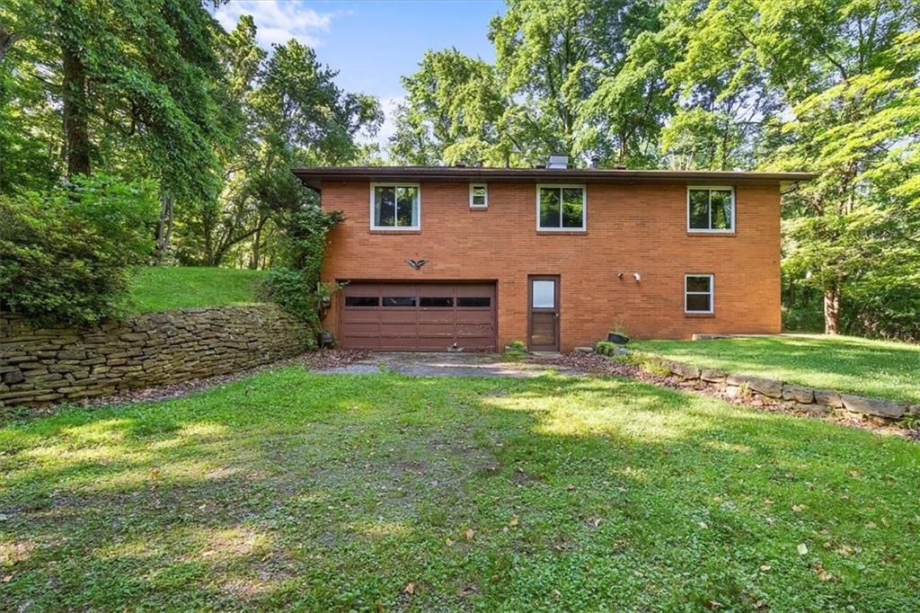 664 Duff Road Sewickley, PA 15143 - Photo 7 of 24 a front view of a house with a garden