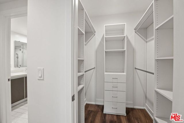 a view of walk in closet with empty racks