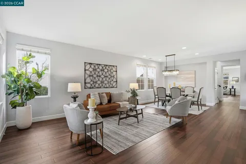 a living room with lots of furniture and a large window