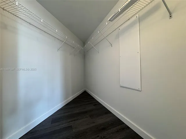 a view of a room with wooden floor and window