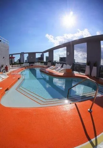 a view of a swimming pool with a lounge chairs