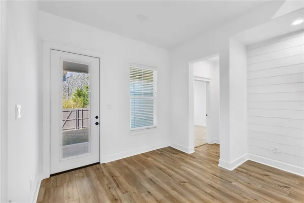 an empty room with window and ceiling fan