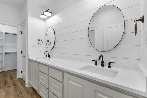 a white toilet sitting next to a white wall