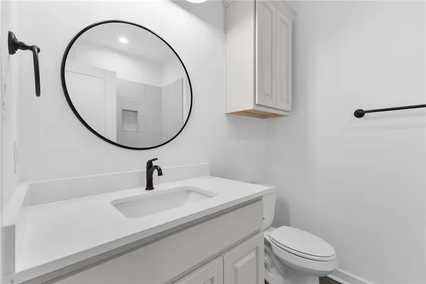 an empty room with a window and a ceiling fan