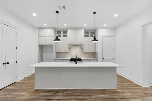 a kitchen with a sink stove and refrigerator