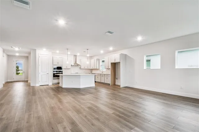 a view of kitchen with kitchen island and stainless steel appliances