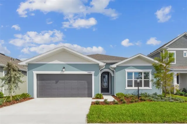 a front view of a house with a yard and garage