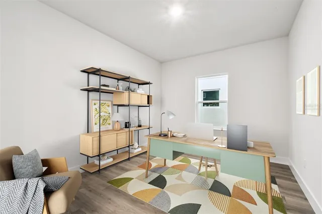 a spacious bedroom with a large bed and a potted plant