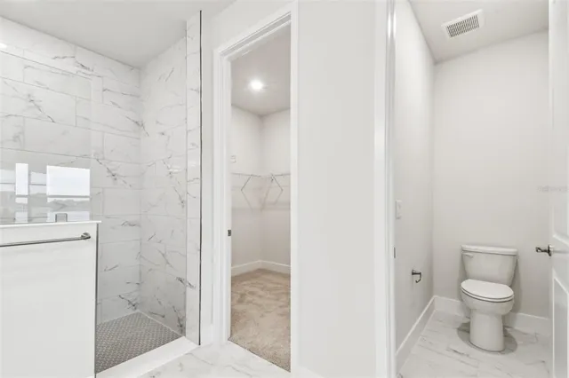 a bathroom with a shower and a sink