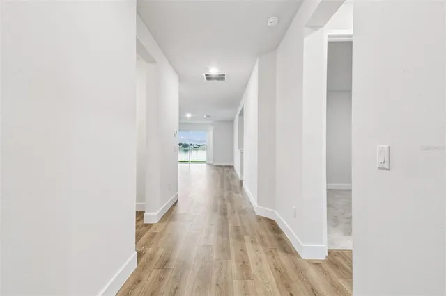 a large kitchen with stainless steel appliances granite countertop a sink a stove and a wooden floors