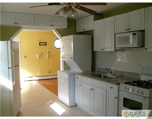 61 Winthrop Road Edison, NJ 08817 - Photo 2 of 6 a kitchen with stainless steel appliances granite countertop a refrigerator a stove and a sink
